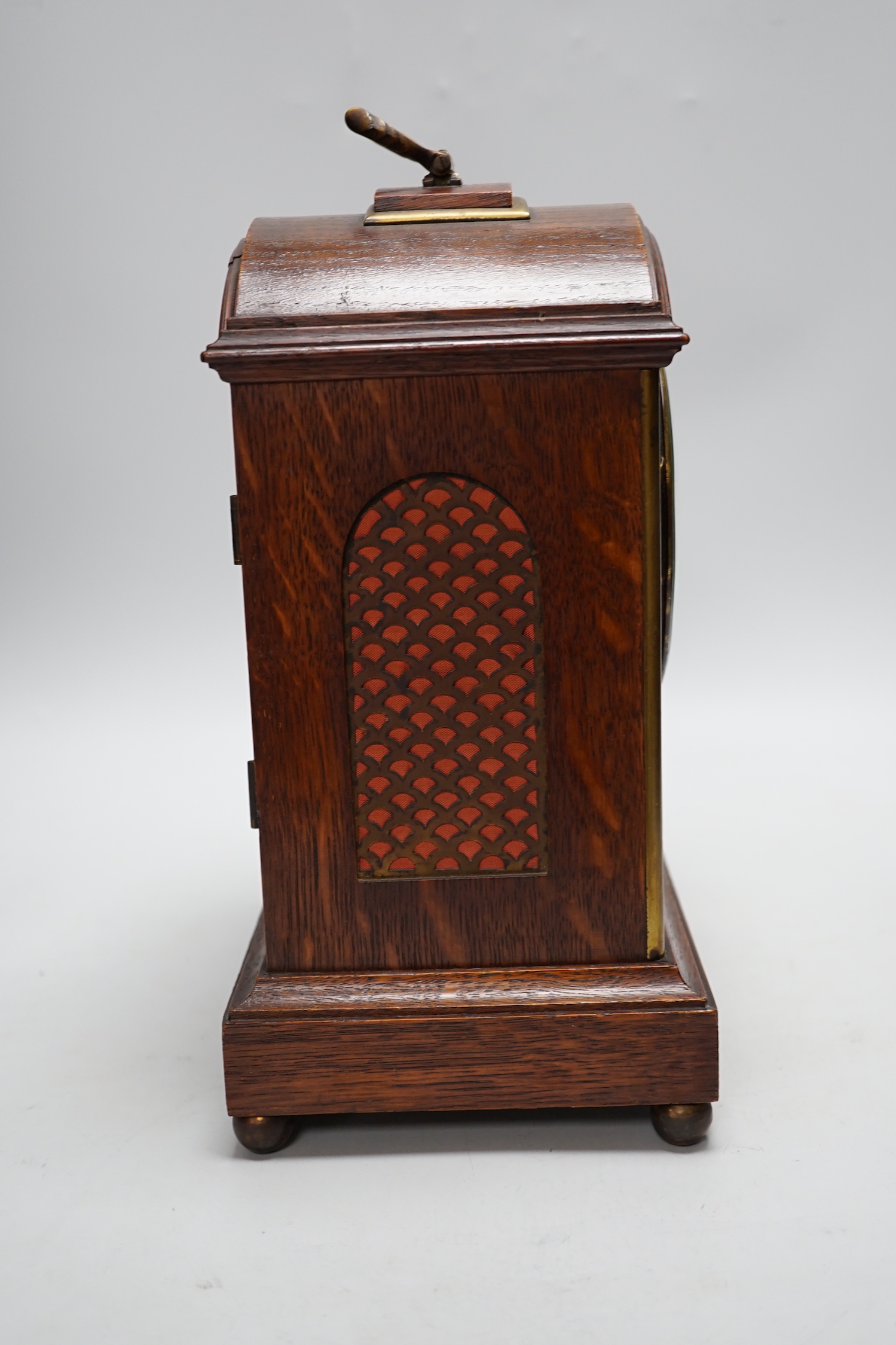 A oak mantel clock in a Regency style with pad top, striking on a coiled gong, 30cm high